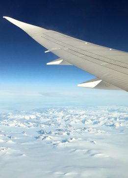 Snow Capped Mountains While Flying Over Greenland