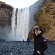 Iceland Waterfalls - Kelly at the Base of the Skógafoss Waterfall