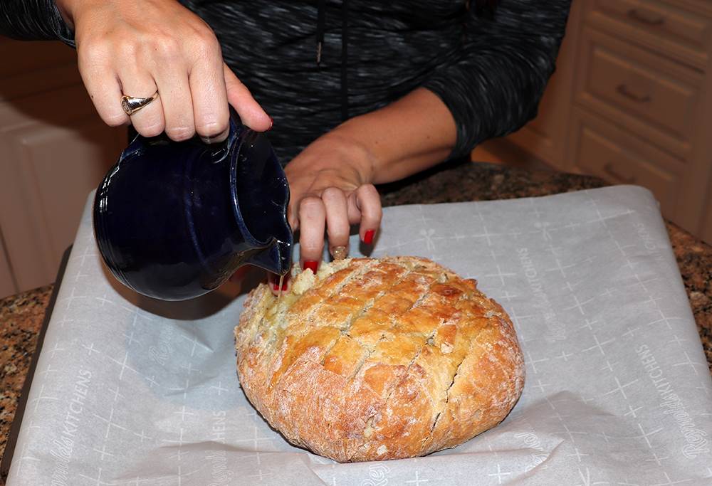 Pouring Butter in Cranberry Brie Pull-Apart Bread Recipe