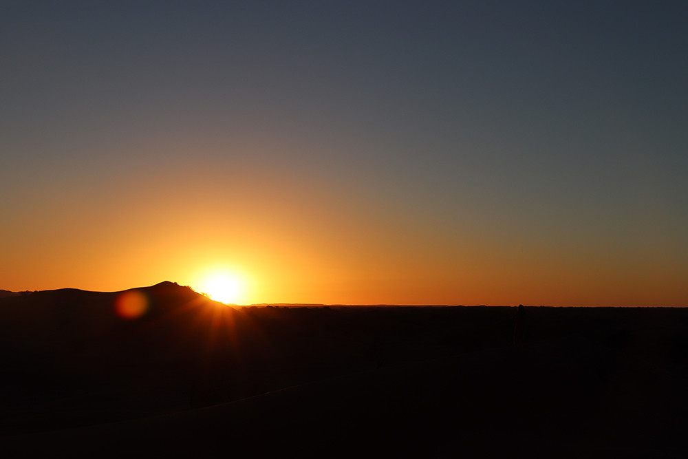 Camping in the Sahara - Burst of Light at Sunrise Over the Dunes