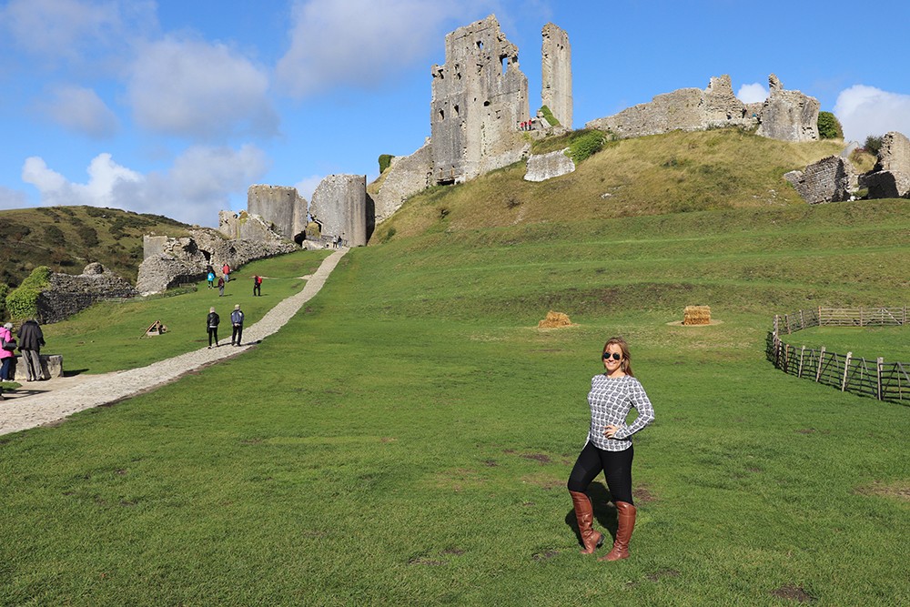 Travel Blogger Kelly Infront of Corfe Castle in Dorset