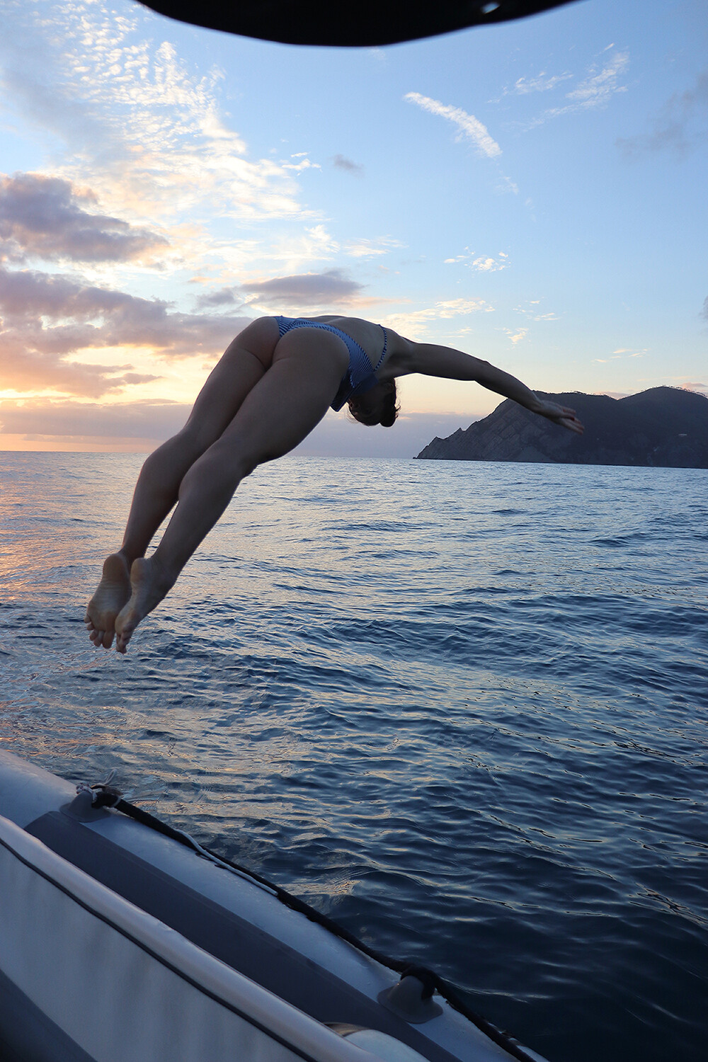 Travel Blogger Diving into the Mediterranean Sea off the coast of Cinque Terre
