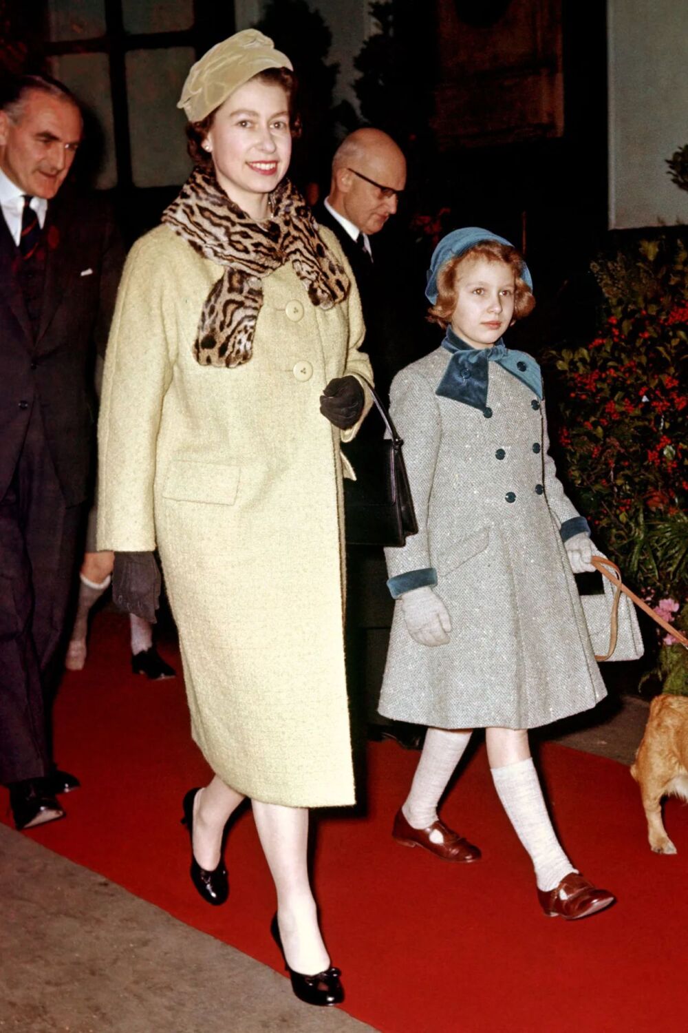 1958 -  lemon coat with a matching hat and a leopard-print scarf at Liverpool Street Station in London -Loomis Dean via British Vogue 