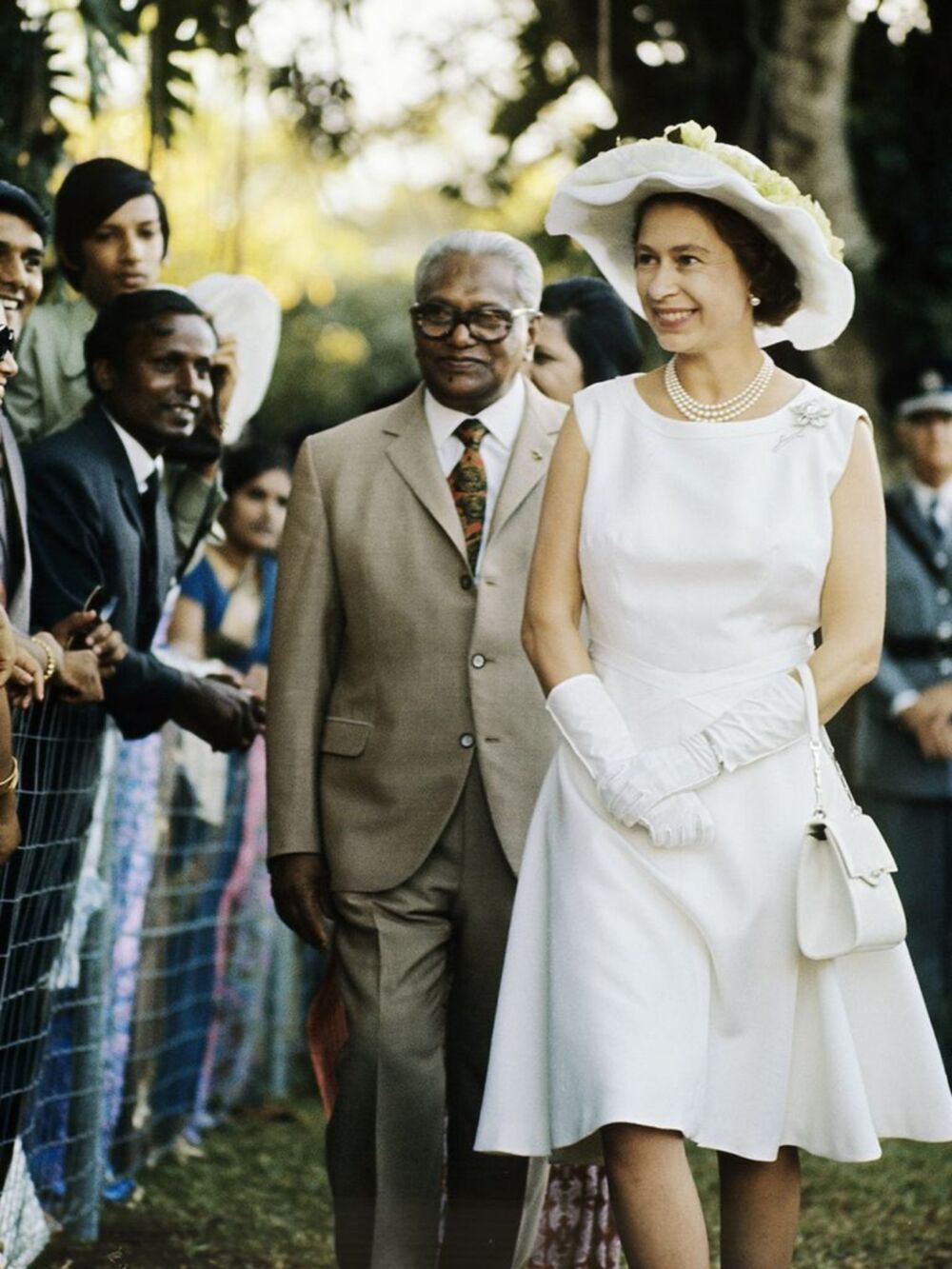 1972 - A classic all-white ensemble while celebrating her Silver wedding celebrations in Mauritius - Getty Images via Marie Claire
