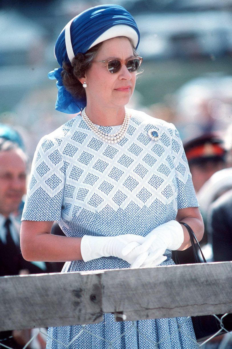 1977 - The Queen wearing a turban style hat and blue ensemble in New Zealand - Getty Images via Marie Claire - Queen Elizabeth II Style