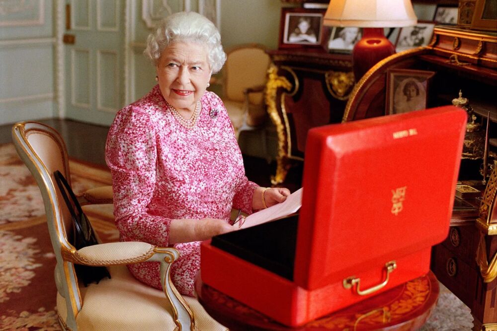 2015 -  Wearing pink  with one of her daily red box dispatches to mark the moment she became the UK's longest-serving monarch - Mary McCartney via The Guardian
