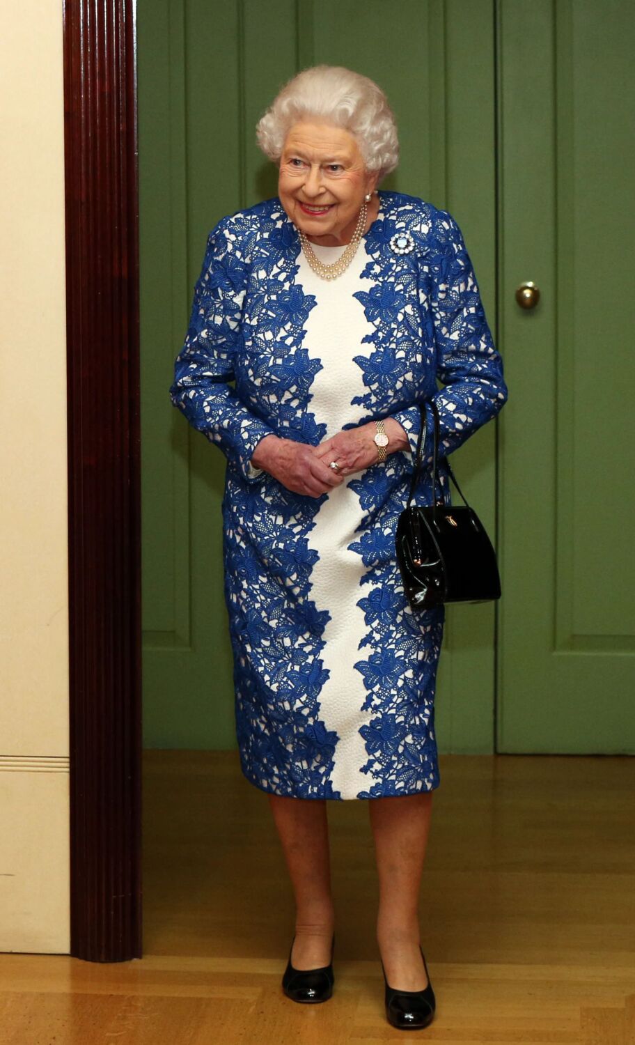 2017 - cream and blue lace dress to attend a reception in London, and carried a Launer handbag - WPA Pool
