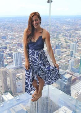 Travel Blogger in Floral High Low Dress at Skydeck Chicago at Willis Tower. Willis Tower Glass Ledge