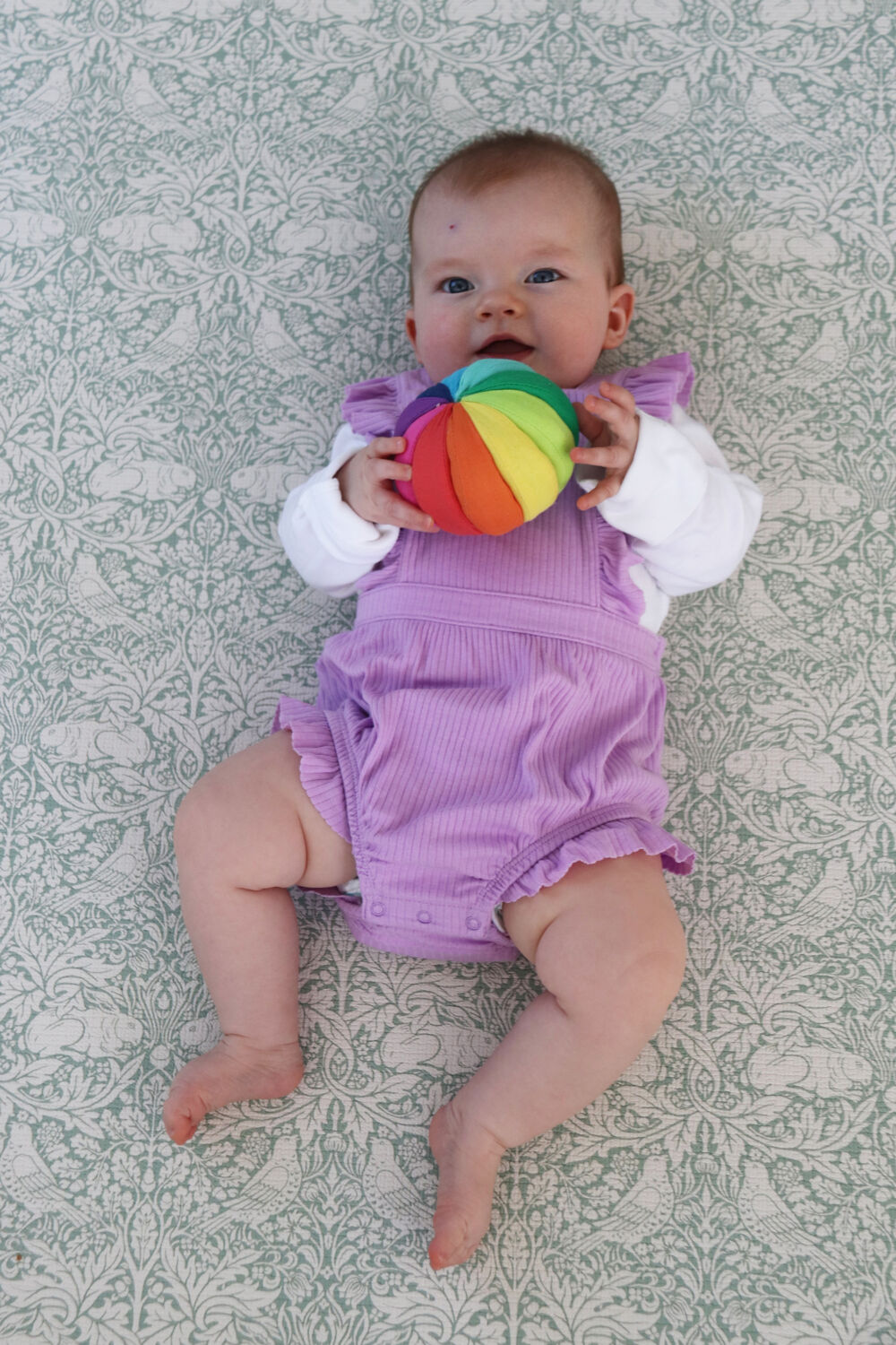Lily chewing on the Cotton Rainbow Ball