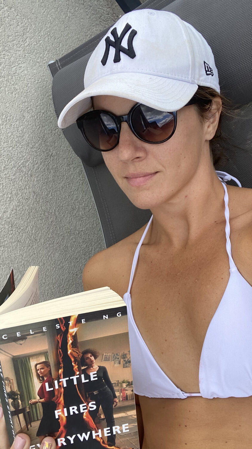 Selfie in White New York Yankees Hat reading Little Fires Everywhere