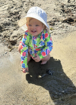 Labor Day 2024 - Lily playing with rocks at the lake wearing Nicole Miller Rashguard and Bottoms
