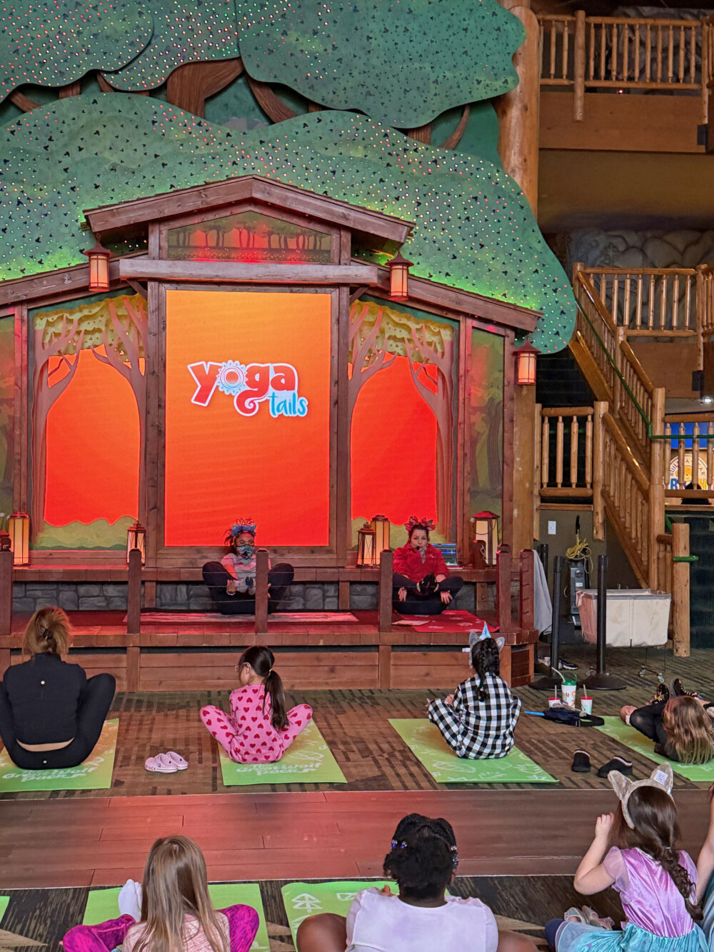 The Yoga Tails stage at Great Wolf Lodge Poconos set up with green mats for the morning kids' yoga class.